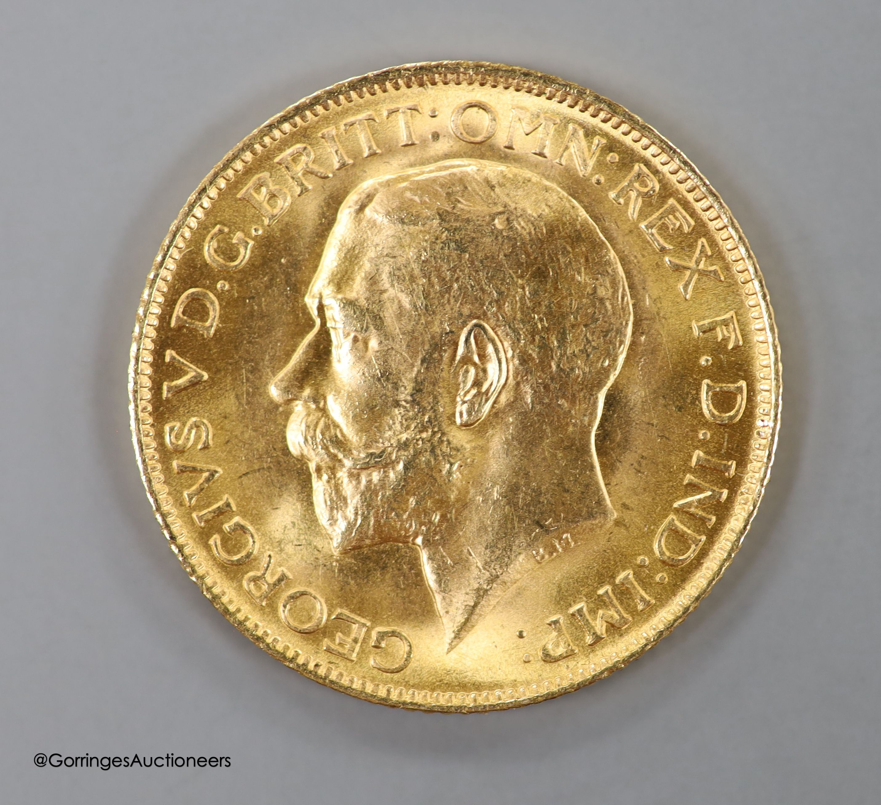 A 9ct gold sovereign case, with engraved monogram, 30mm, gross weight 15.6 grams, containing a George V 1911 gold sovereign